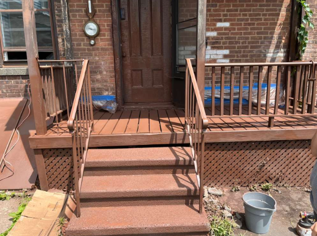 Porch after renovation with fresh paint and restored steps