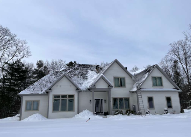 Professional roof snow removal - front view of residential home